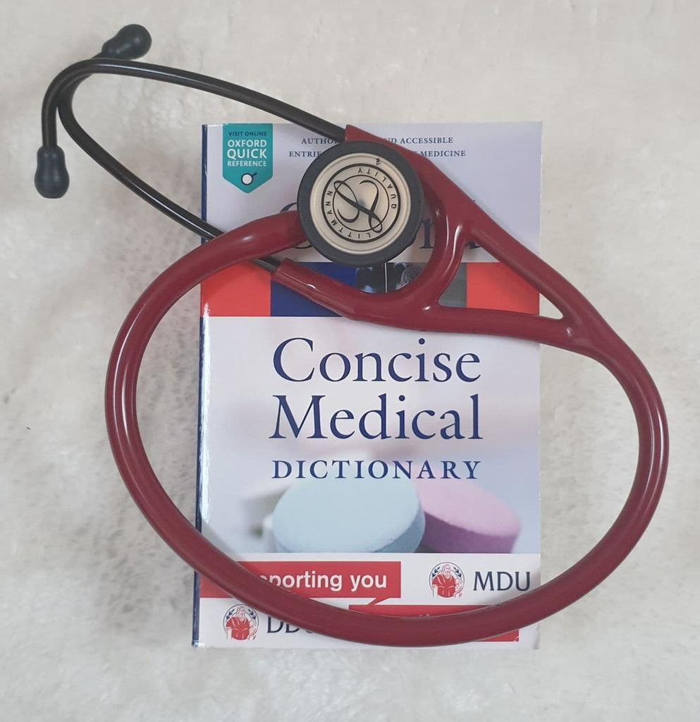 A picture of Julia's Stethoscope and medical dictionary, laid out on a desk